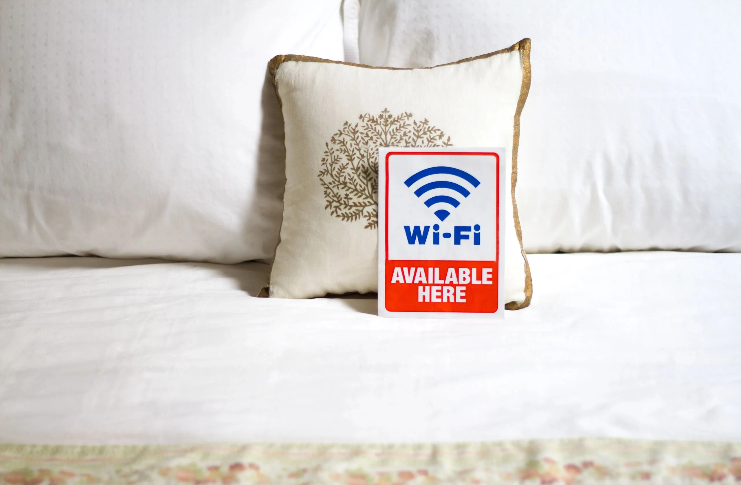Wi-Fi available sign on bed linens representing reliable connectivity